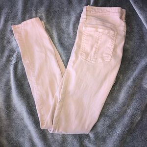 Distressed light pink jeans